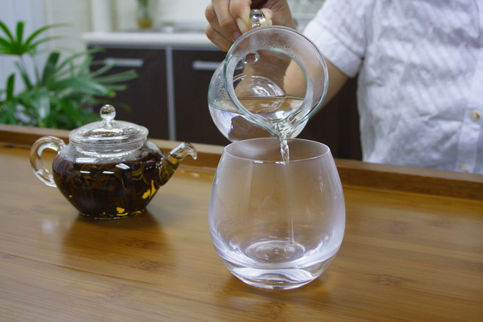 In the mean time, pour off the hot water from the pitcher into the glass to warm it up.