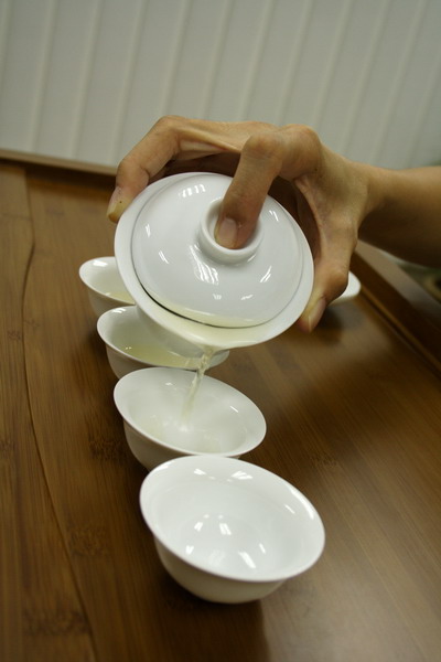 Pour straight into all the cups and move back and forth to equalize the concentration of tea for each cup.