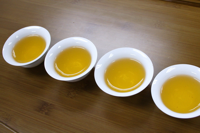 The photo shows serving tea using Chinese tea cup.